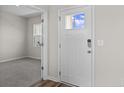 Bright entryway with white door and view into an adjacent room with carpet at 3059 Deerberry Place, Longs, SC 29568