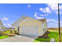 Rear view of a new home showcasing its exterior features and landscaping at 3059 Deerberry Place, Longs, SC 29568