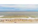 Beachfront property with blue umbrellas and ocean waves at 2207 S Ocean Blvd. # 1516, Myrtle Beach, SC 29577
