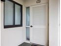 Condo entry with white door and two windows with blinds at 669 Retreat Beach Circle # C2G, Pawleys Island, SC 29585