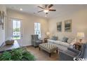 Living room with hardwood floors, sofas, chairs, and a ceiling fan at 2810 Cook Circle # D, Myrtle Beach, SC 29577