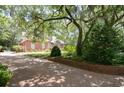 Brick driveway with landscaping and mature trees at 232 Inverness Dr., Pawleys Island, SC 29585