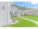 House exterior showing gray siding, blue shutters, and walkway at 1616 Sapphire Dr., Longs, SC 29568