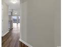Hallway leading into a spacious living area with hardwood floors at 5040 Windsor Green Way # 302, Myrtle Beach, SC 29579