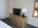 Bedroom with dresser, TV, and ample storage at 1501 S Ocean Blvd. # 848, Myrtle Beach, SC 29577