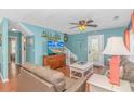 Beach house living room with light blue walls, comfortable seating, and stairs at 6001- 1029 S Kings Hwy., Myrtle Beach, SC 29575