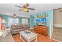 Beach-themed living room with a large TV, comfortable seating, and stairs at 6001- 1029 S Kings Hwy., Myrtle Beach, SC 29575