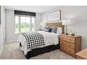 King bed in a bedroom with black and white decor at 8906 Freya Way # 24A, Longs, SC 29568