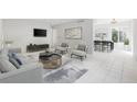 Open living room with tile floors, dining area, and modern furniture at 800 9Th Ave. S # T-4, North Myrtle Beach, SC 29582