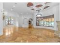 Spacious living room with high ceilings, a fireplace, and large windows at 8056 Cortona Dr., Myrtle Beach, SC 29572