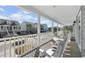 Relaxing front porch with rocking chairs and street view at 619 Springs Ave., Pawleys Island, SC 29585