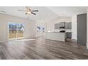 Open concept kitchen with gray cabinets, granite countertops, and stainless steel appliances at 316 Lakota Loop, Longs, SC 29568