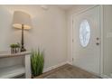 Bright entryway with decorative table, lamp, and plant at 615 Snowy Owl Way, Conway, SC 29527