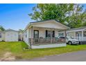 Quaint cottage with a porch and well-maintained yard at 6001-5137 S Kings Hwy., Myrtle Beach, SC 29575