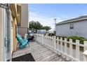 Outdoor deck with teal chairs and a grill, near a fenced yard at 6001 - M-58 S Kings Hwy., Myrtle Beach, SC 29575