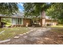 Backyard view of brick house with patio and landscaping at 6300 Highway 701 South, Conway, SC 29527