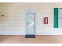 Exterior condo front door with welcome mat and fire extinguisher at 472 River Oaks Dr. # 65C, Myrtle Beach, SC 29579