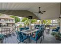 Covered patio with seating, dining, and a TV for outdoor entertainment at 6001 - Mh202 S Kings Hwy., Myrtle Beach, SC 29575