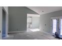 Open concept living space with light green walls and white kitchen cabinets at 604 Highway 747, Loris, SC 29569