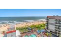 Oceanfront view of building, pool, and beach at 7200 N Ocean Blvd. # 853, Myrtle Beach, SC 29572