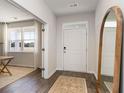 Bright entryway with hardwood floors, large mirror, and view into an office at 129 Pampa Dr., Loris, SC 29569