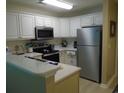 Galley kitchen with stainless steel appliances and white cabinets at 562 Blue Stem Dr. # 54R, Pawleys Island, SC 29585