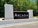 Arcadia community entrance sign with white pillars and black lettering at 308 Happy Valley Dr., Myrtle Beach, SC 29588