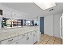 White kitchen with breakfast bar, marble countertops, and ocean view at 5511 N Ocean Blvd. # 306, Myrtle Beach, SC 29577