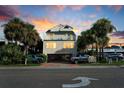Two-story beach house with parking and palm trees at sunset at 4314 S Ocean Blvd. # B-1, North Myrtle Beach, SC 29582