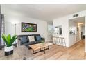 Open concept living room with light hardwood floors and kitchen views at 4303 S Ocean Blvd. # 107, North Myrtle Beach, SC 29582