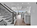 Elegant staircase with wrought iron railing, view to kitchen and living area at 312 West Palms Dr., Myrtle Beach, SC 29579