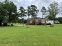 Side view of a brick house with a large grassy yard at 880 Horry Rd., Aynor, SC 29511