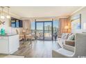 Ocean view living room with comfy seating and dining area at 6900 Ocean Blvd. N # 1205, Myrtle Beach, SC 29572