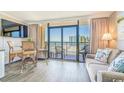 Living room with ocean view, balcony access, and seating at 6900 Ocean Blvd. N # 1205, Myrtle Beach, SC 29572
