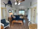 Bright living room with comfy seating, dining area, and hardwood floors at 1521 N Waccamaw Dr., Murrells Inlet, SC 29576