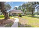 Inviting curb appeal with a spacious front yard and mature trees at 60 Wraggs Ferry Rd., Georgetown, SC 29440