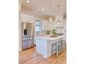 Bright kitchen with white cabinets, stainless steel appliances, and island at 8165 Living Tide Dr., Myrtle Beach, SC 29572