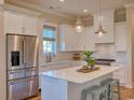 Bright kitchen with white cabinets, stainless steel appliances, and island at 8165 Living Tide Dr., Myrtle Beach, SC 29572