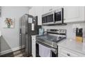 Well-equipped kitchen with stainless steel appliances and white cabinetry at 4503 W Harbour Circle # S1, Little River, SC 29566