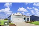 Newly built light blue house with white garage door at 3050 Deerberry Place, Longs, SC 29568