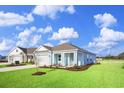 New construction home with a light blue exterior and landscaping at 3050 Deerberry Place, Longs, SC 29568