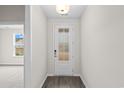 Bright entryway with white door, wood-look floors, and a window at 512 Sheepbridge Way, Loris, SC 29569