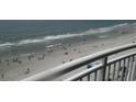 Beach view from balcony showcasing the ocean and beachgoers at 201 S Ocean Blvd. # 1109, Myrtle Beach, SC 29577