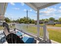 Relaxing front porch with two chairs overlooking the neighborhood at 2403 Park St., North Myrtle Beach, SC 29582