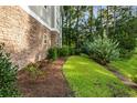 Landscaped area with stone wall and lush greenery at 125 S Shore Blvd. # 302, Longs, SC 29568