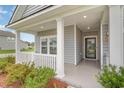 Front porch with white columns and gray siding at 837 Brant St., Myrtle Beach, SC 29588