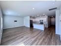 Open living room features wood-look floors and an island kitchen at 163 Marsh Deer Place, Surfside Beach, SC 29575