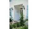 White front door and light blue shutters on a brick home at 201 River Rd., Georgetown, SC 29440