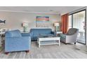 Bright living room with comfy sofas, coffee table, and ocean view at 2805 N Ocean Blvd. # 301, Myrtle Beach, SC 29577