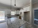 Modern kitchen featuring white cabinets, granite countertops, and an island at 1039 Sioux Swamp Dr., Conway, SC 29527